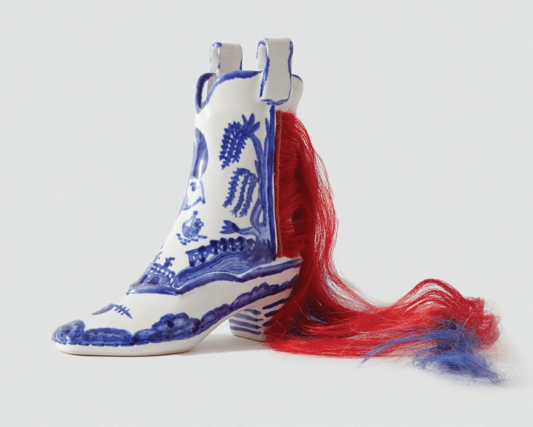 Upcoming art exhibit piece depicting a blue and white beaded shoe with intricate patterns and a red feather motif, symbolic of blending heritage craftsmanship with contemporary design.