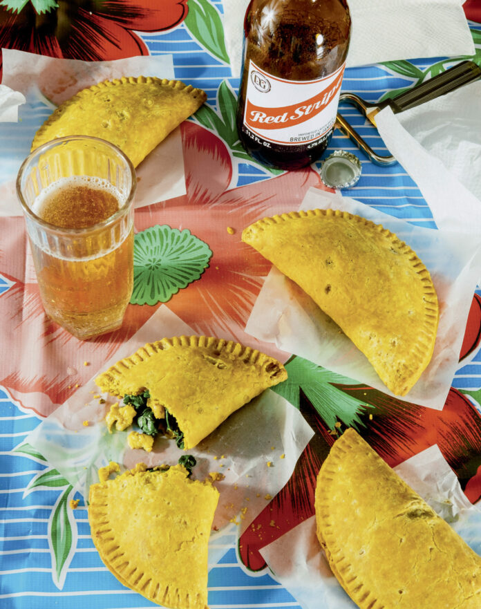 Four Jamaican Style Ackee sit on a colorful floral tablecloth.