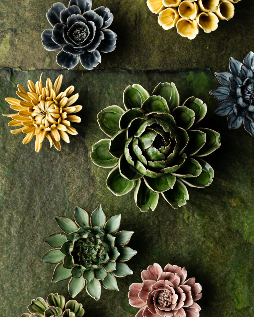 Ceramic flowers in soft greens, pinks, and yellows