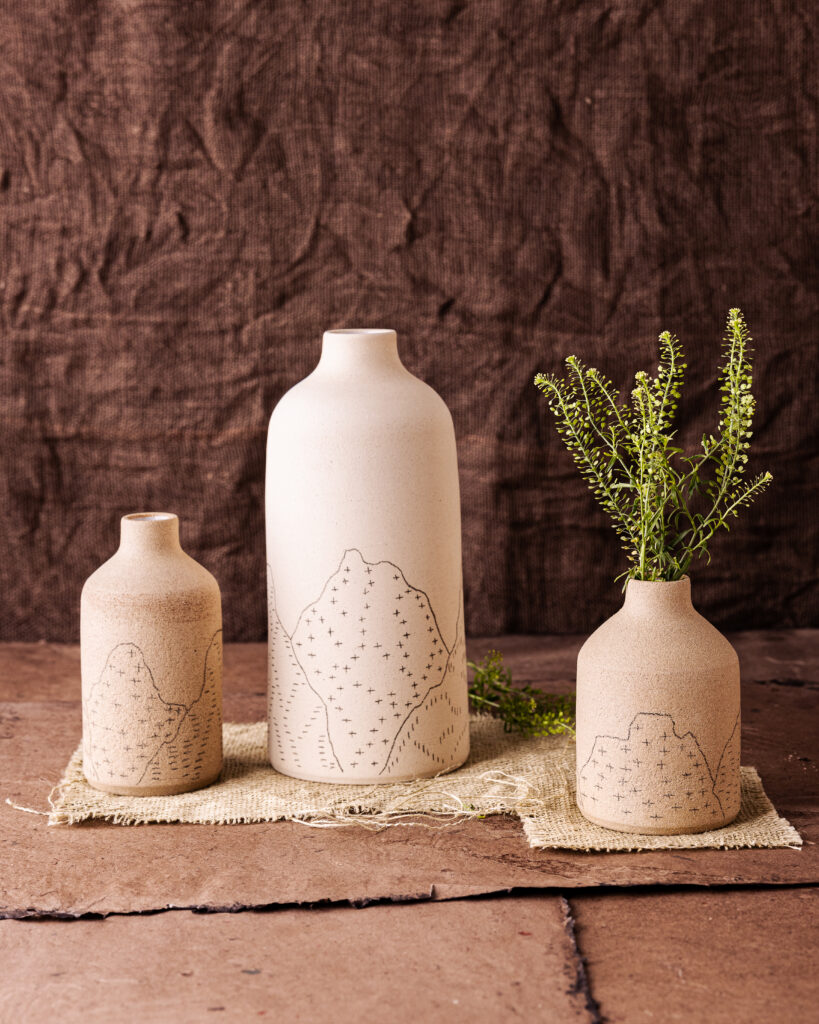 White stoneware vases incised with iconic Southwest images, textures and landscape elements