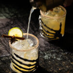 An apple cider margarita in a Halloween-inspired glass