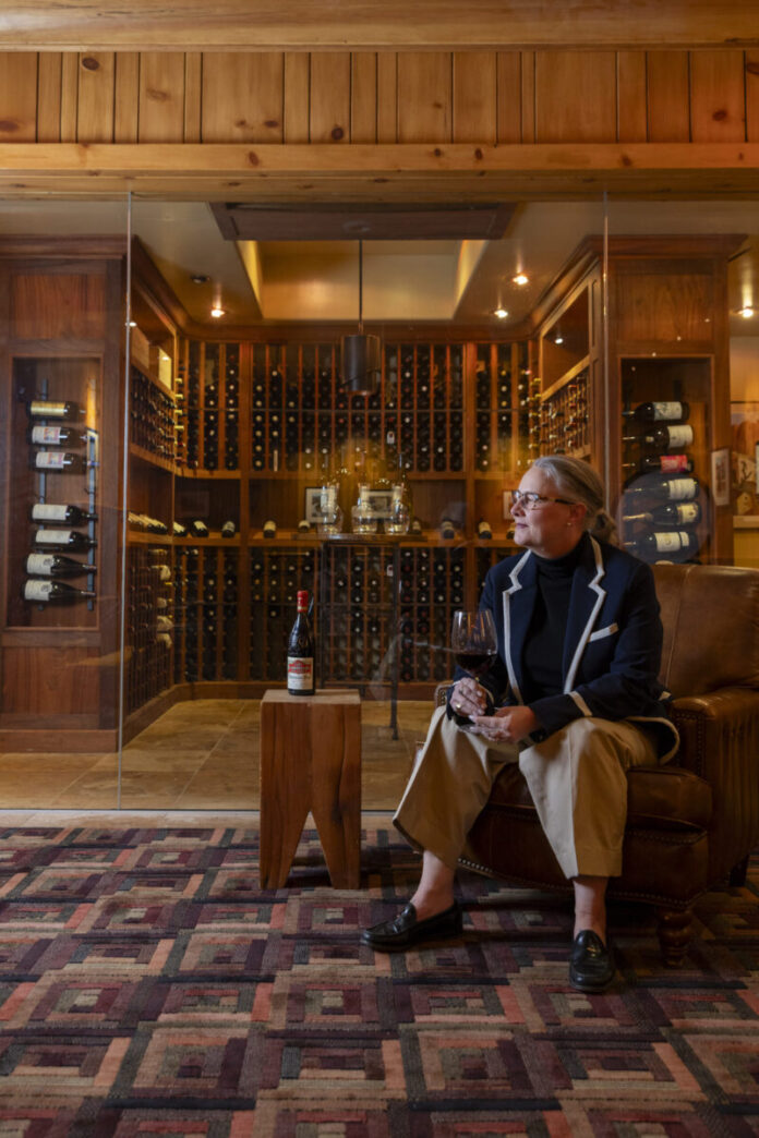 Kristina Hayden Bustamante, Santa Fe Sommelier, sitting and showcasing exquisite wine selection at Rio Chama Prime Steakhouse