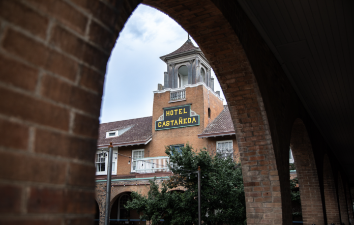 An outside shot of the Castañeda Hotel shot through an archway during a staycation.