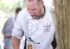 The History of Santa Fe Wine & Chile Fiesta A man in a white chefs coat dresses small appetizers.