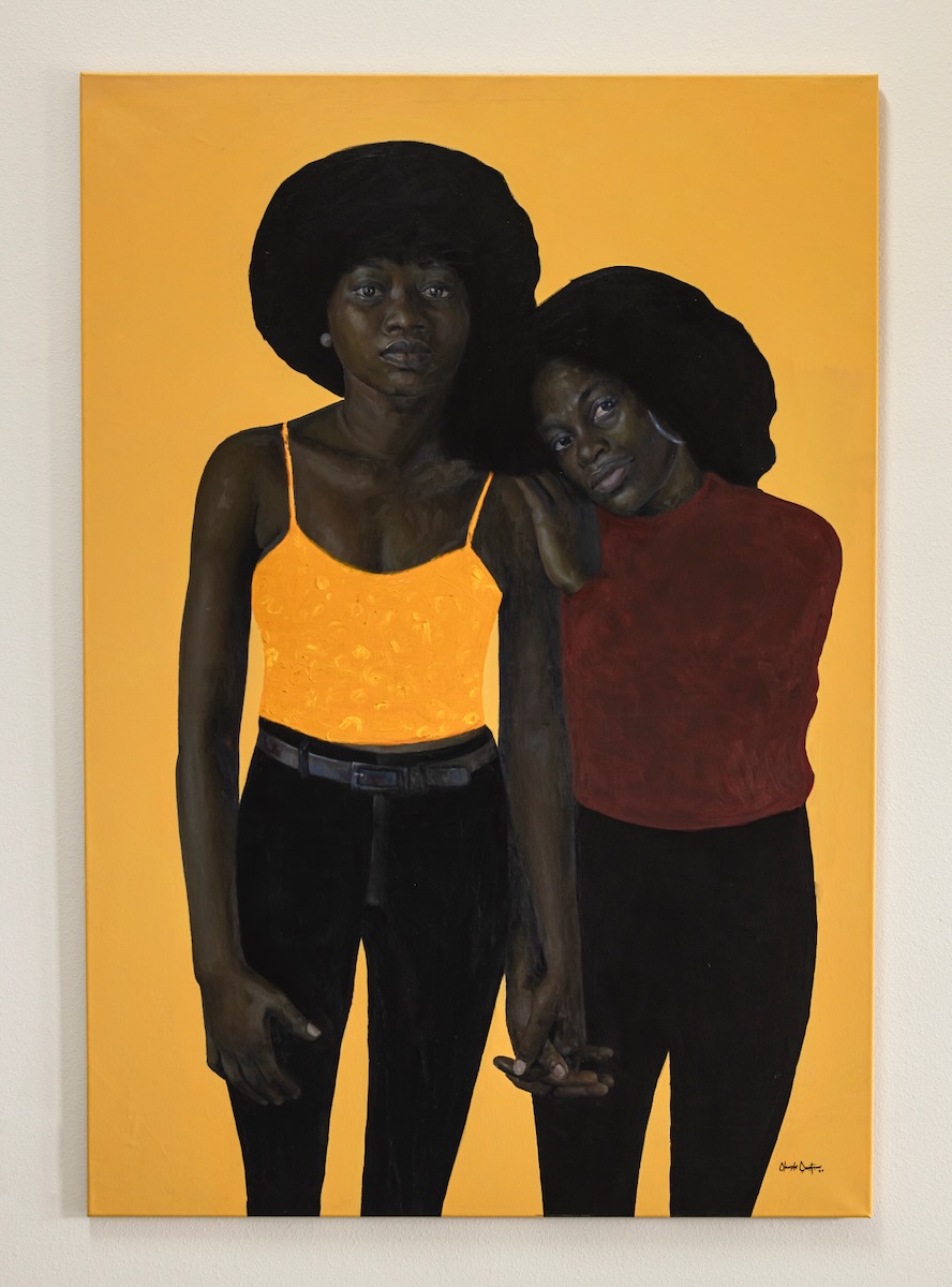 A painting with a yellow background featuring two young Black girls for Juneteenth.