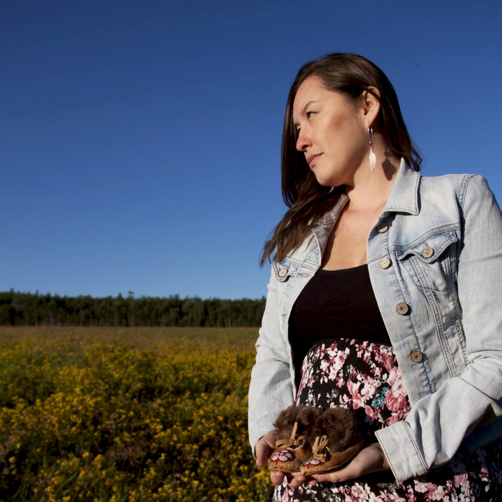 Vashti Etzel in a field around a blue sky 