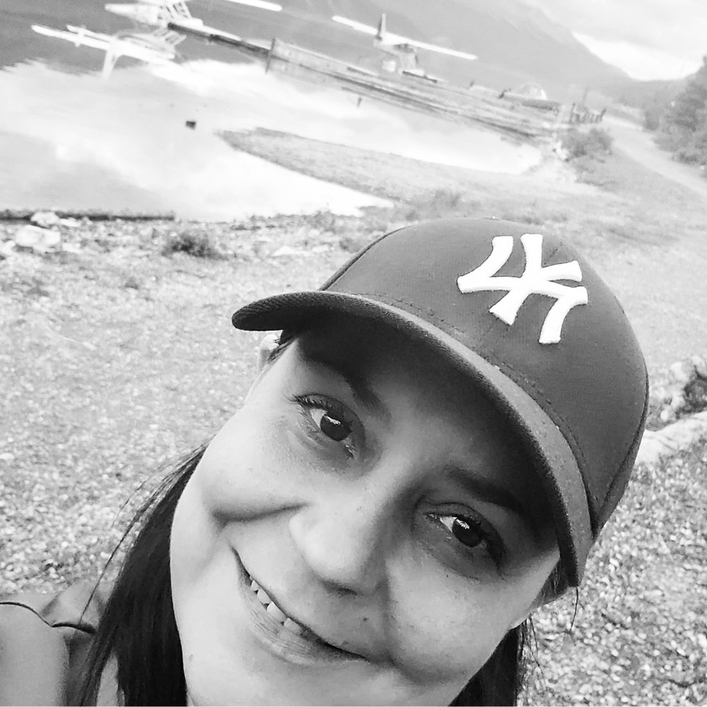 Amy Tessaro, a Native American woman in a New York Yankee's hat, in black and white 