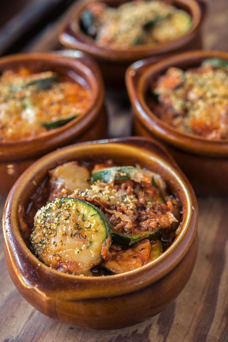 Small plates of zucchini mixed with roasted vegetables