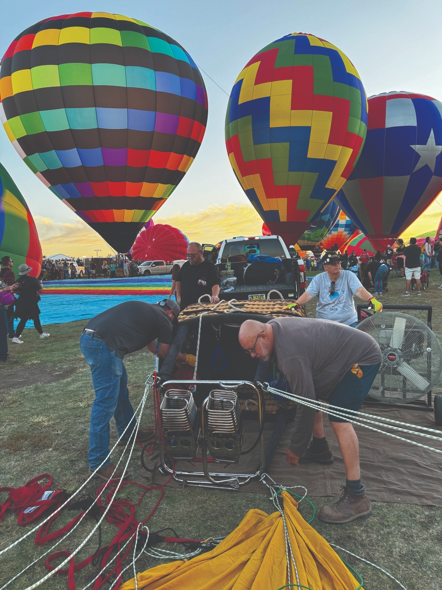 Participants preparing colorful hot air balloons at the Albuquerque International Balloon Fiesta.