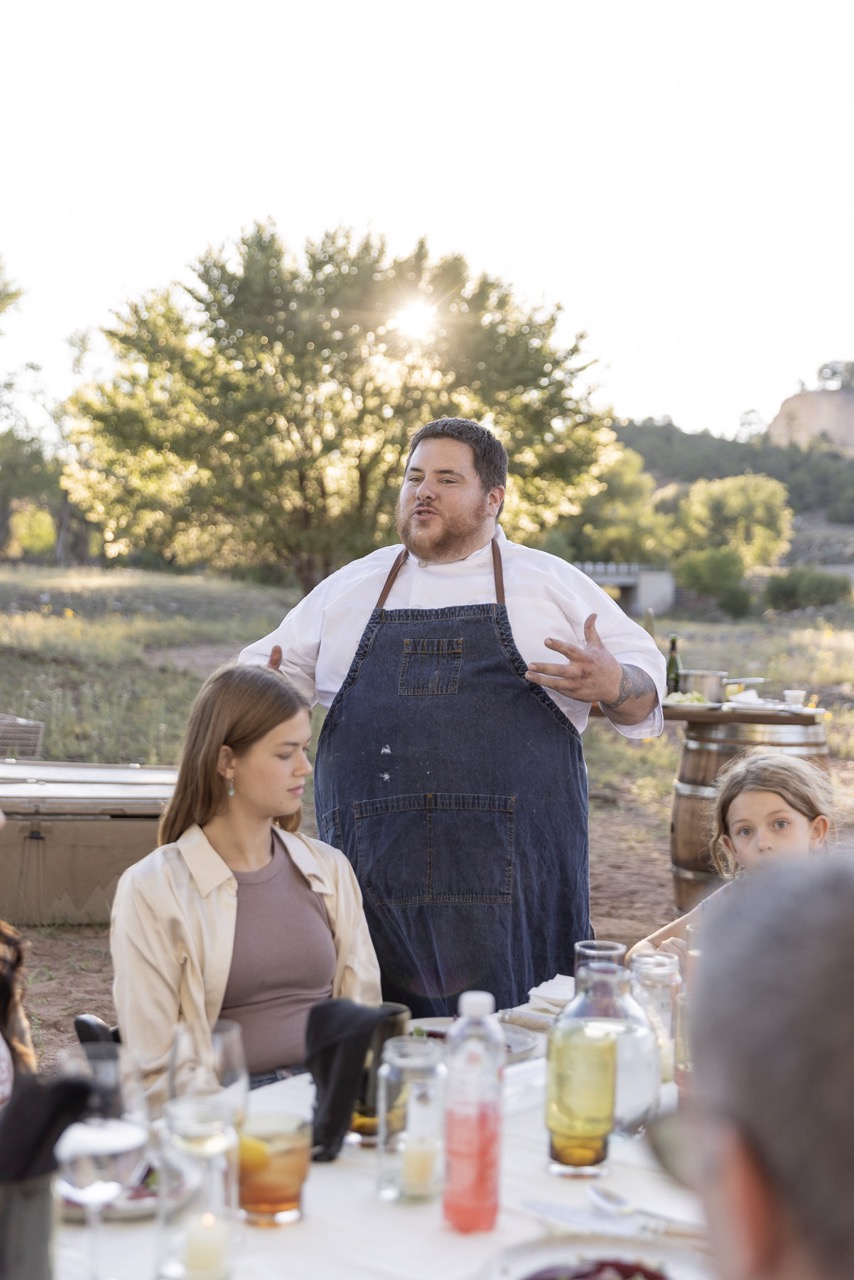 A chef speaks to a group of dinners outside at Beck and Bulow.