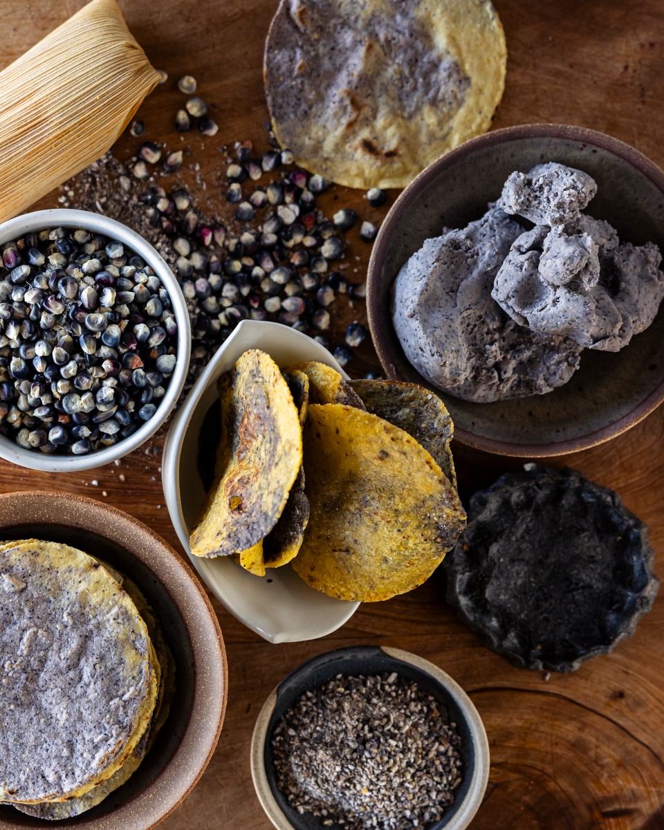 A variety of delicious baked goods displayed on a wooden surface with bowls nearby.