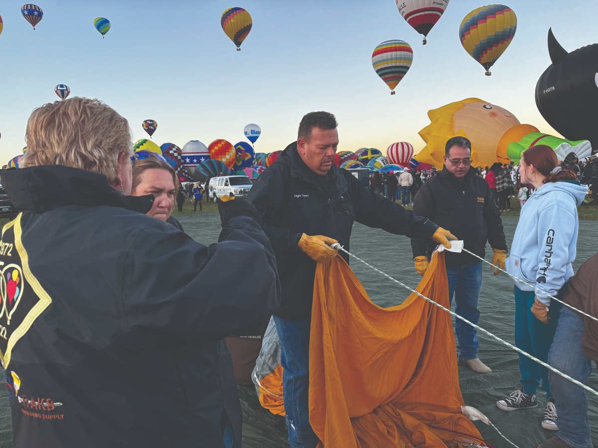 Balloonists preparing a hot air balloon for lift-off at the Albuquerque International Balloon Fiesta.