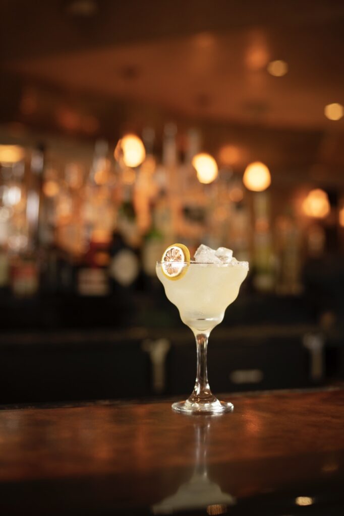 A Winter Staycation at El Monte Sagrado A cocktail sits in a tall glass on a wooden bar.