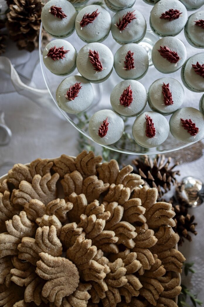 Two platters of holiday cookies sit beside each other.