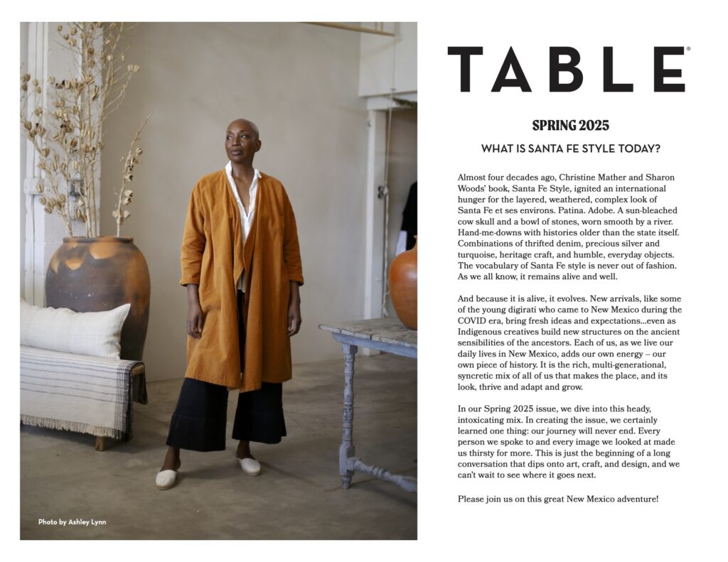 A magazine layout with a woman standing in a brown coat on the left and TABLE text on the right.