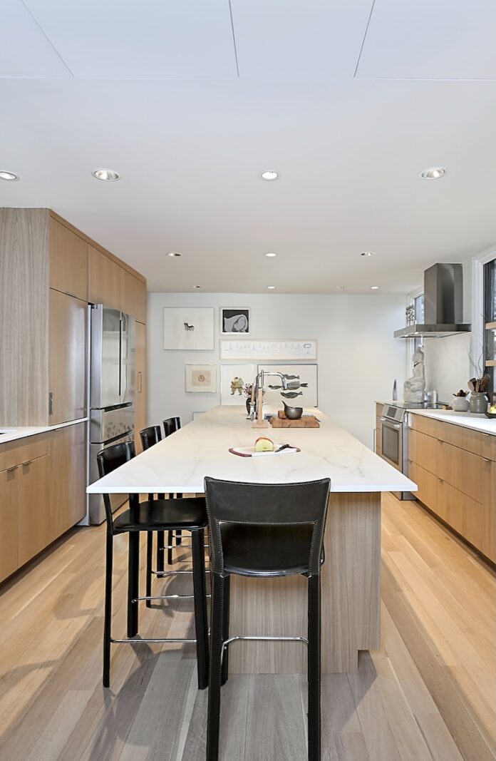 2025 Excellence in Remodeling Award Winners from Builders Journal A remodeled kitchen in white and brown cupboards as a winner of Builders Journal's 2025 Excellence in Remodeling Award winners.
