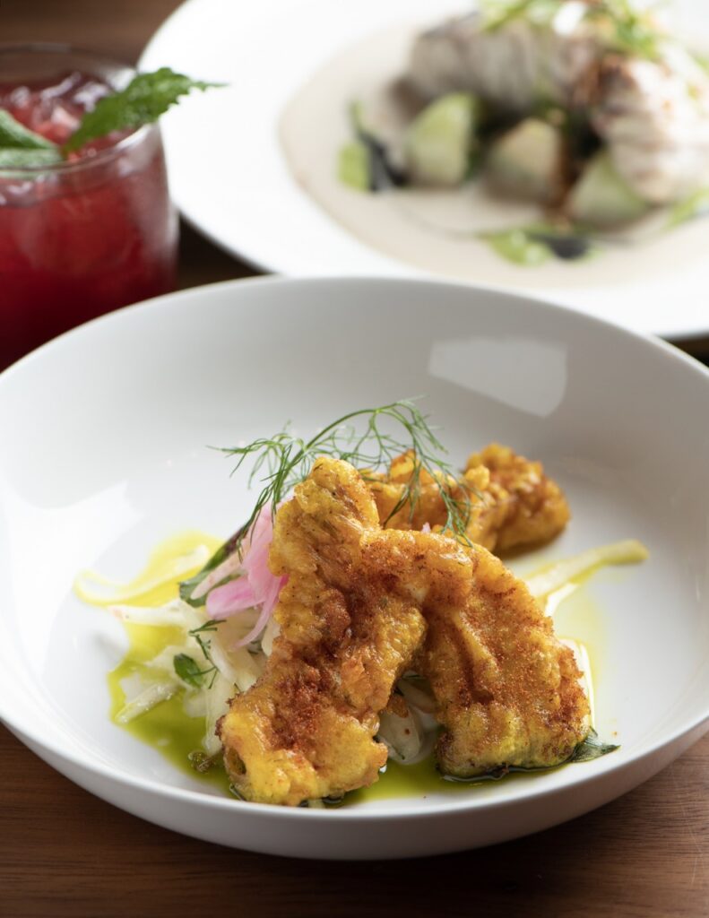 Food from Santa Fe's Alkeme featuring fried cod on a white plate. 