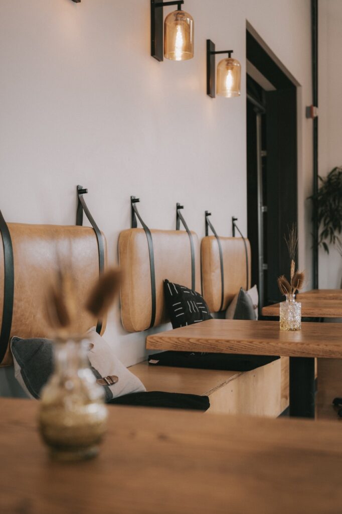 A group of brown booths and tables against the wall at a Santa Fe restaurant.