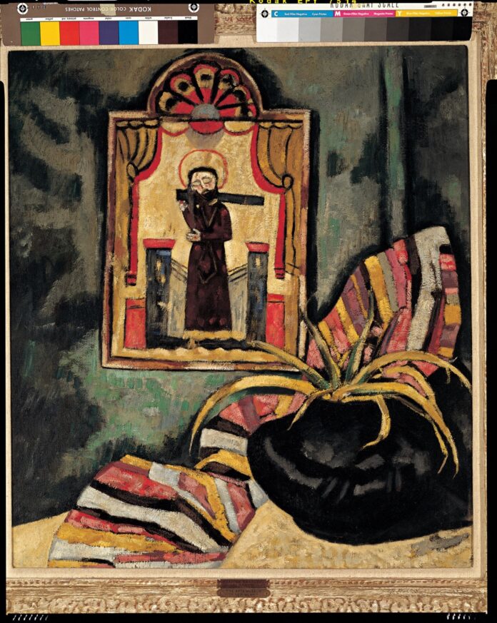 The New Mexico Museum of Art Showcases Marsden Hartley A Marsden Hartley painting of a window on a wall with a woman on the other side in dull colors.