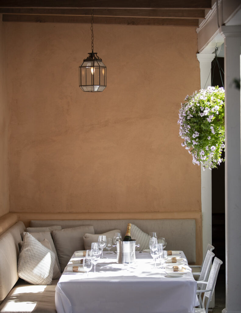 Elegant outdoor dining setup at SantaCafe with a beautifully set table, cozy seating, and soft natural lighting.