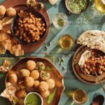 Kachori fritters staged on a blue piece of wood surrounded by colorful sauces.