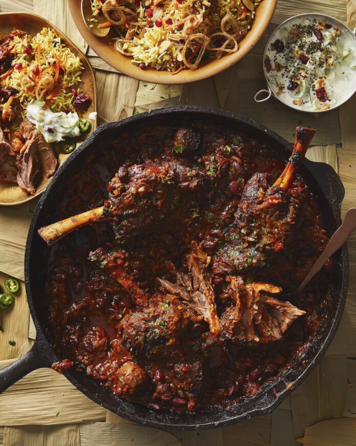 Persian Lamb Stew Persian lamb stew for Nowruz, staged with other sides on a light brown table.