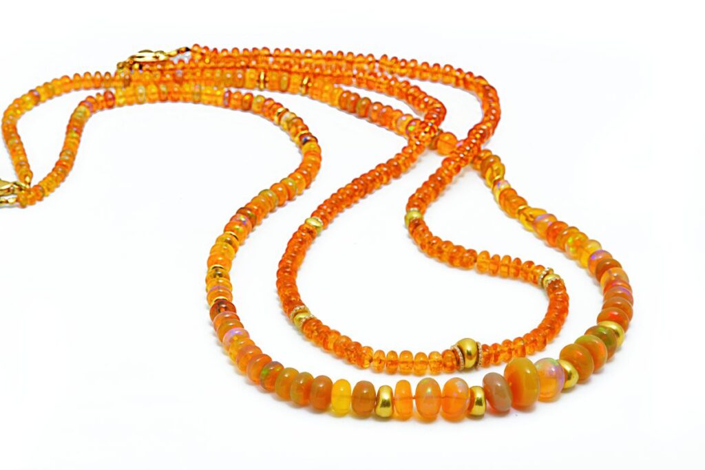 A close-up of two necklaces on a white background.