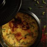 A plate of Korean stamed eggs on a black surface.