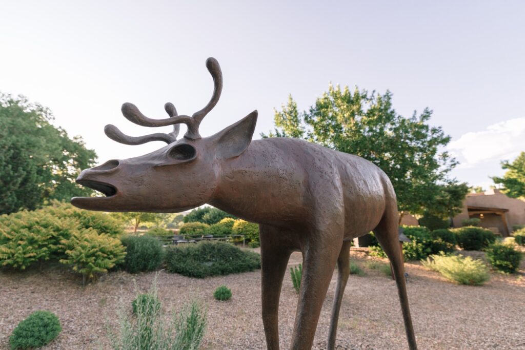 Bronze sculpture of a stylized deer-like animal.