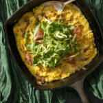 an aerial shot of Roasted Green Chile Polenta with Prosciutto and Mexican Asadero. a Polenta recipe