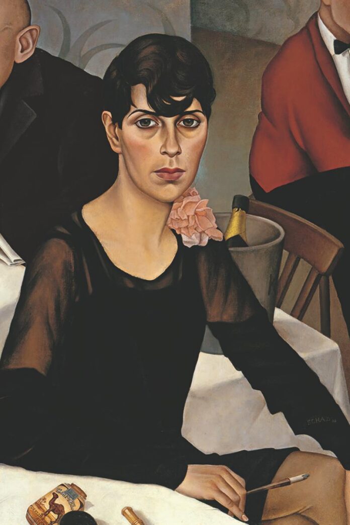 A portrait painting of a woman with short dark hair, wearing a black dress and a light pink flower pinned to her shoulder, sitting at a table with a bucket holding a champagne bottle.