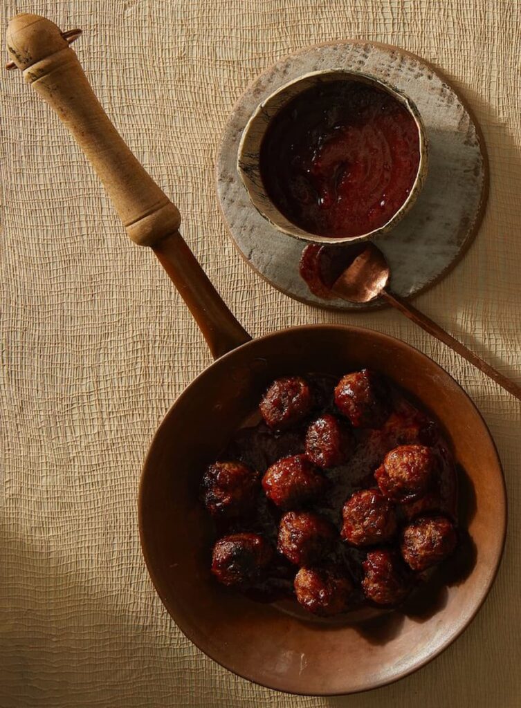 Flavorful meatballs in cranberry gojuchang sauce, creating a harmonious blend of sweet, savory, and spicy flavors, perfect for a satisfying and delicious meal.