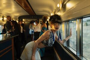 Native Fashion Week 2025 21 TABLE Magazine A woman bends over to look out the bus window.