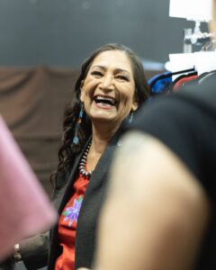 Native Fashion Week 2025 4 TABLE Magazine A woman smiles and laughs in passing.