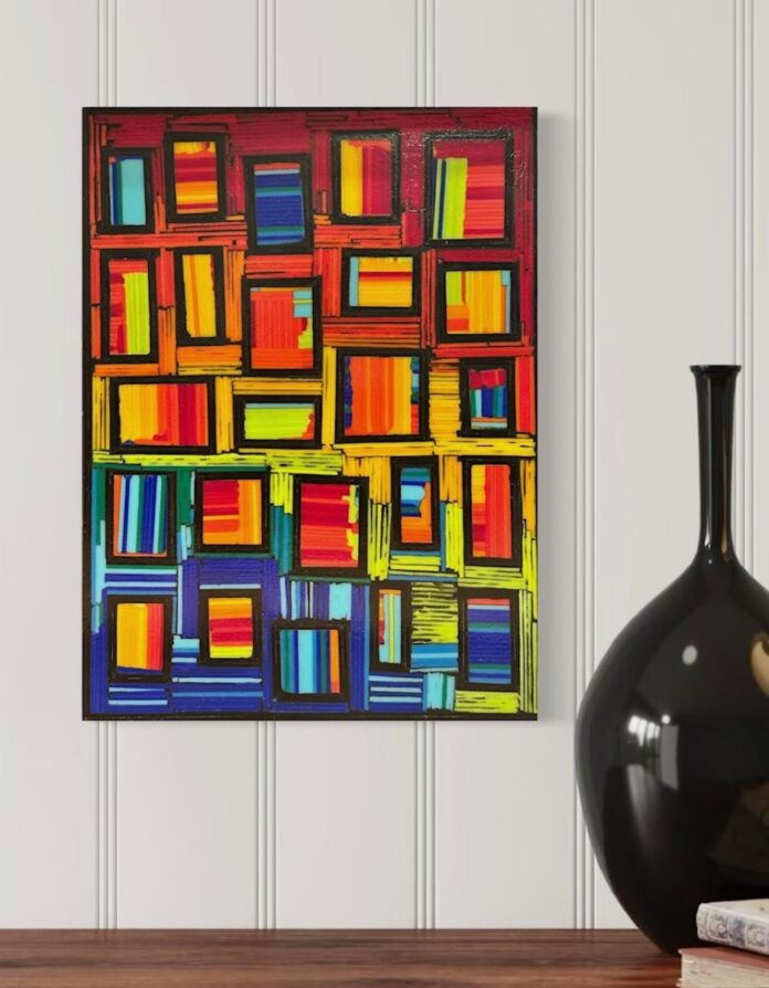 An abstract painting composed of a grid of small rectangles filled with vibrant, horizontal strokes of red, orange, yellow, and blue hangs on a white wall.