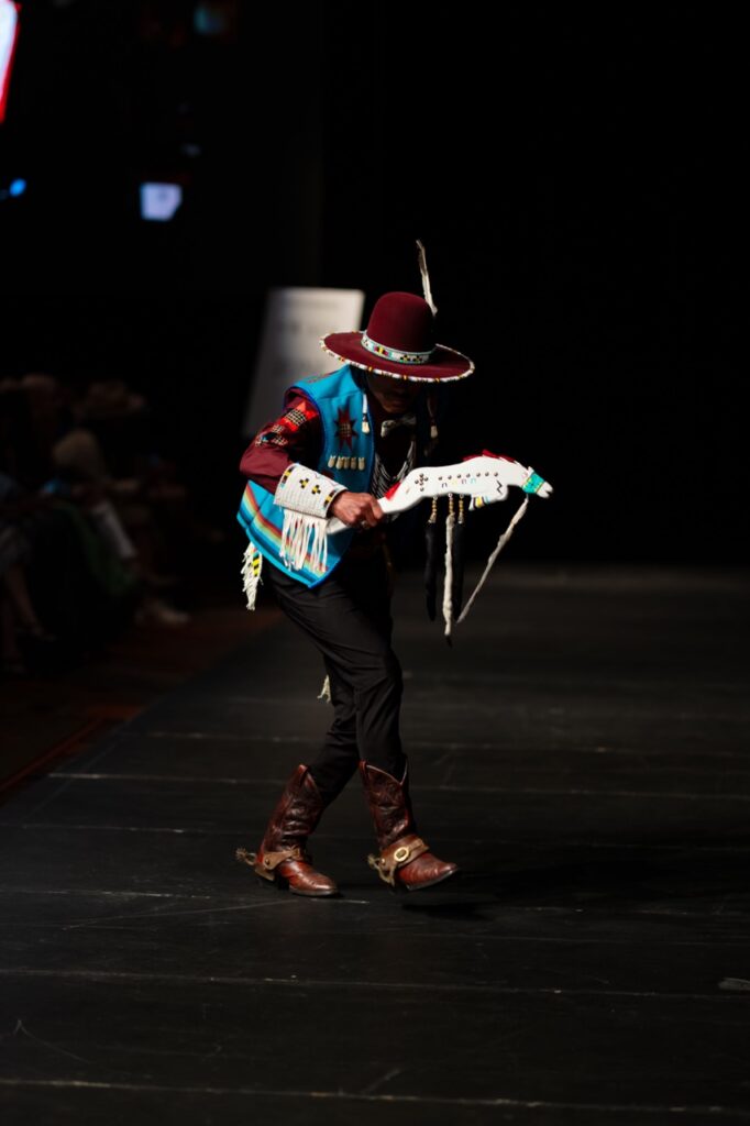 SWAIA Native Fashion Week 9 TABLE Magazine A man in native gear walks on a fashion runway.