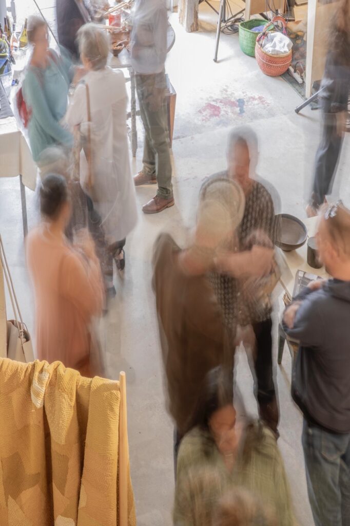 Spring Launch Party 17 TABLE Magazine Blurry photo of people talking to each other.