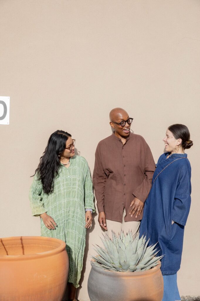 Spring Launch Party 19 TABLE Magazine Three people talk and smile outside.