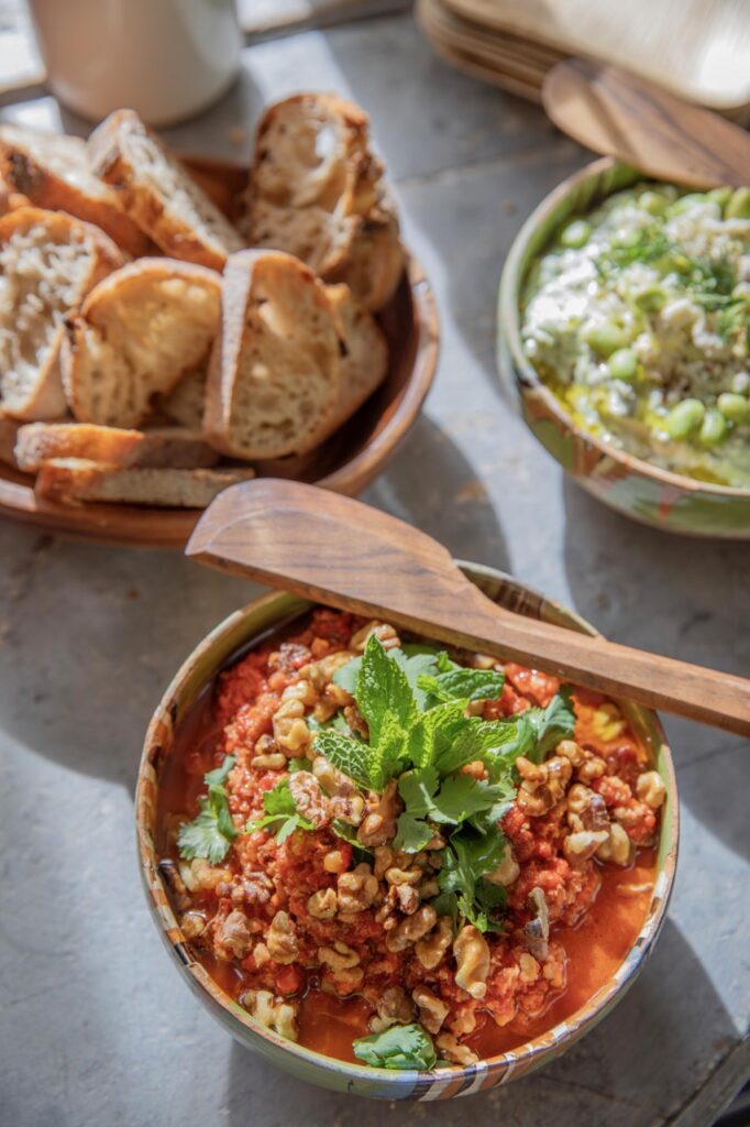 Spring Launch Party 2 TABLE Magazine A chili in a bowl with bread nearby.