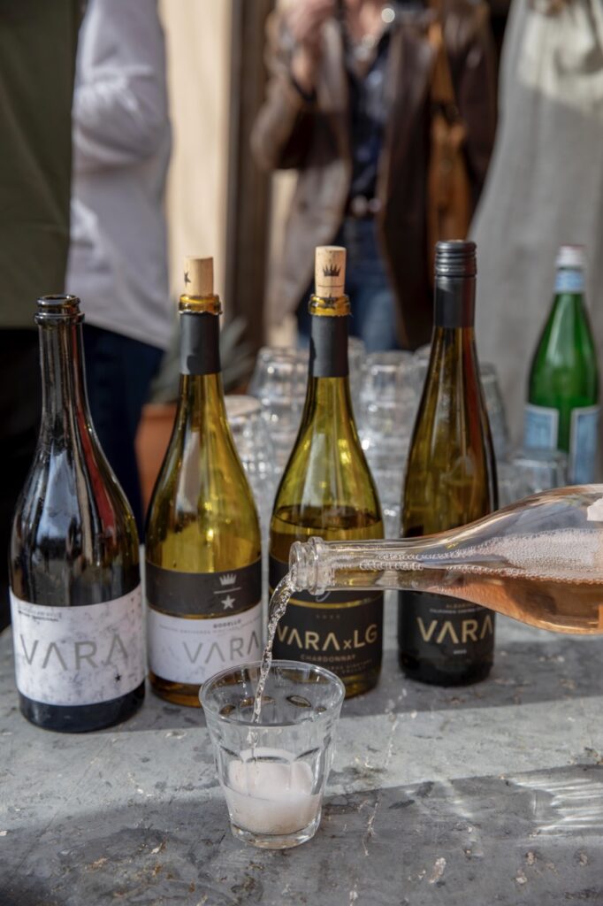Spring Launch Party 20 TABLE Magazine A bottle of Vara wine pours in front of four other bottles.