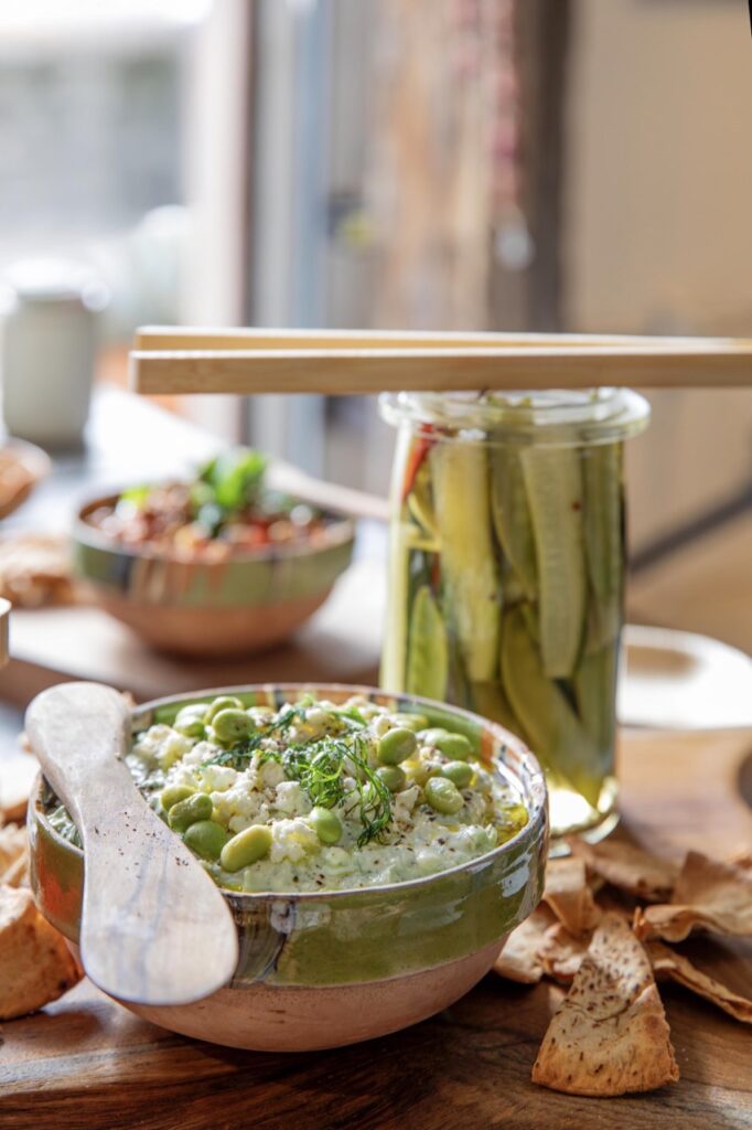 Spring Launch Party 6 TABLE Magazine A green dip sits in front of a jar of pickles.