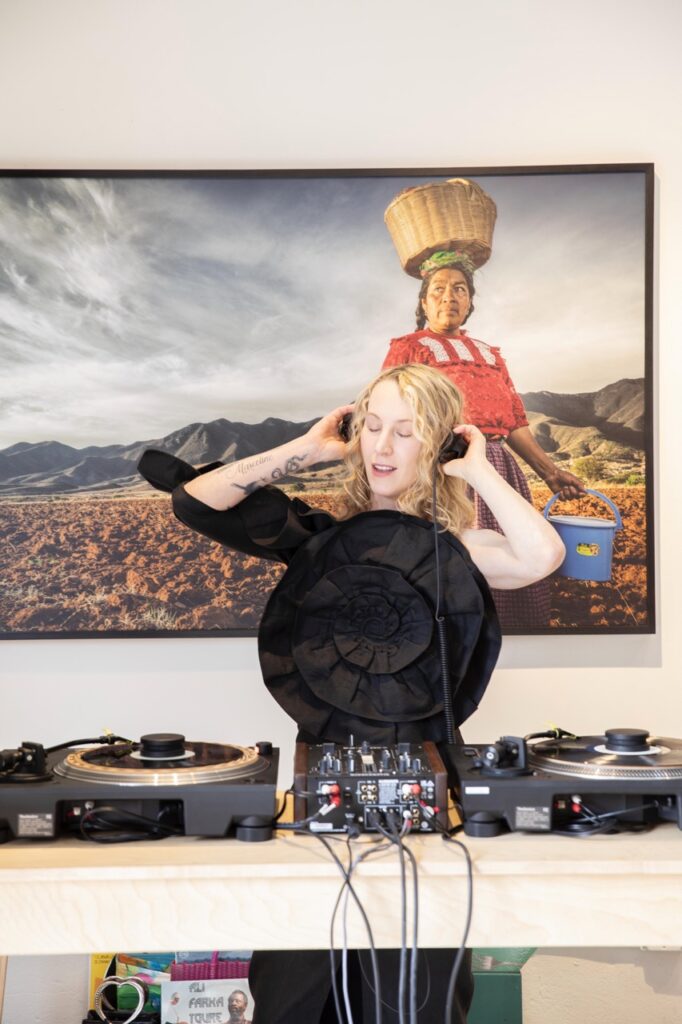 Spring Launch Party 7 TABLE Magazine A woman Djs with headphones on.