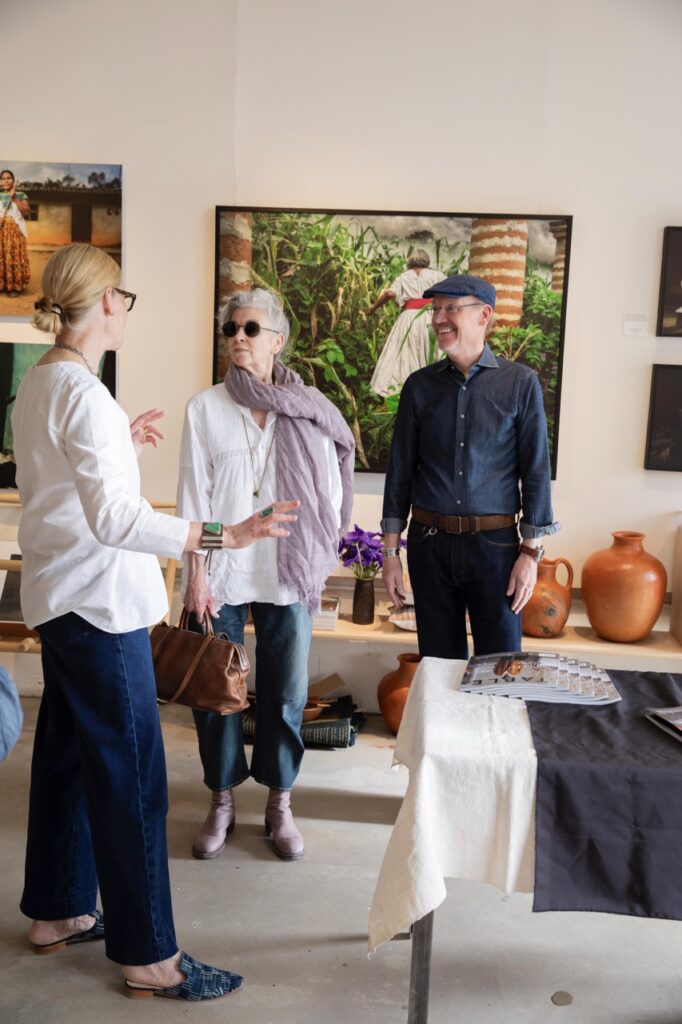 Spring Launch Party 9 TABLE Magazine A woman in white welcomes a couple into Living Threads.