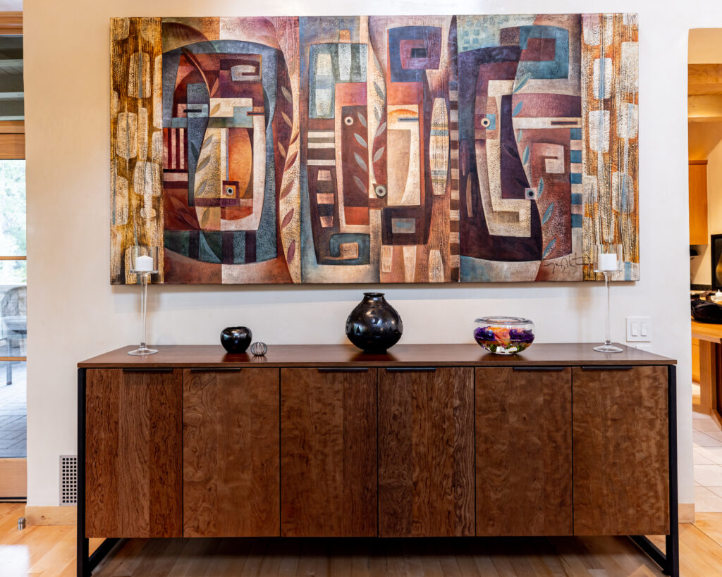 side brown table with painting hanging over top