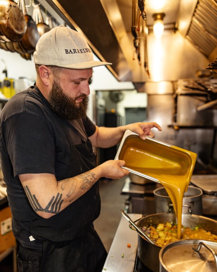 Farm to Soul Man puring sauce from deep pan