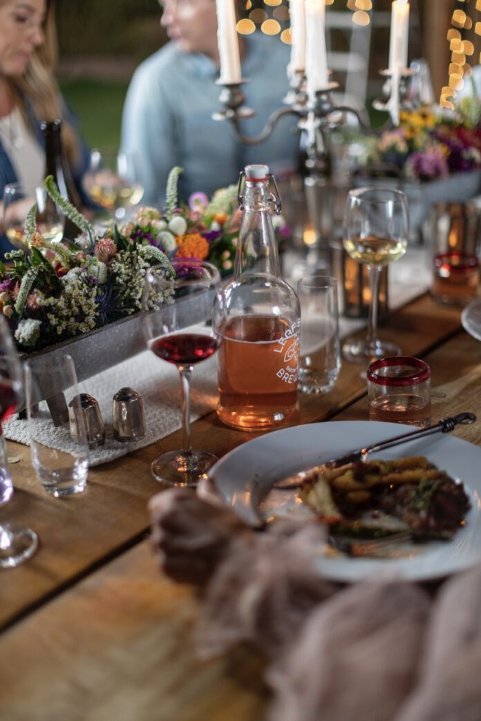 A table full of wine glasses and dinner plates.