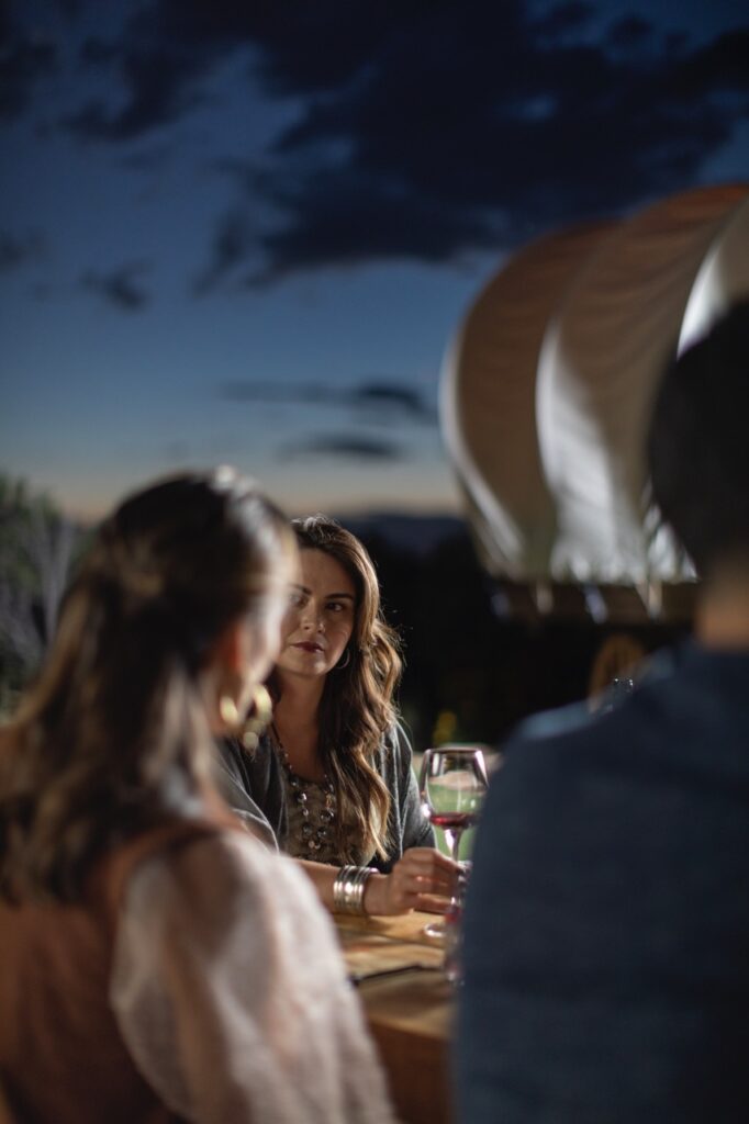 People at a table talk to each other.