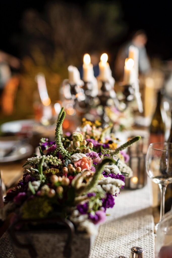 A glamping table setting with florals and candles.
