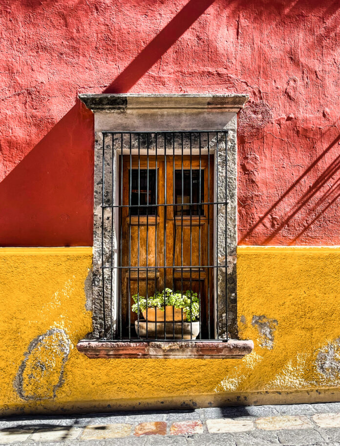 Window on half red half yellow painted wall