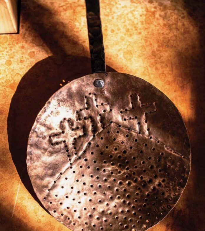 Spanish metalworker spoon with patterns.